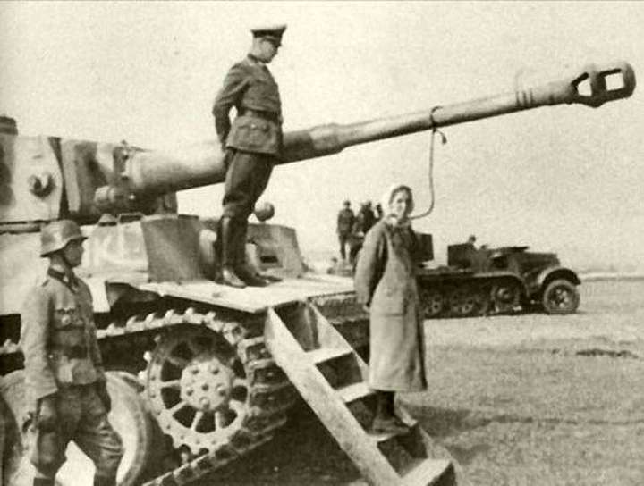 Nazis hang Jewish woman from tank barrel.